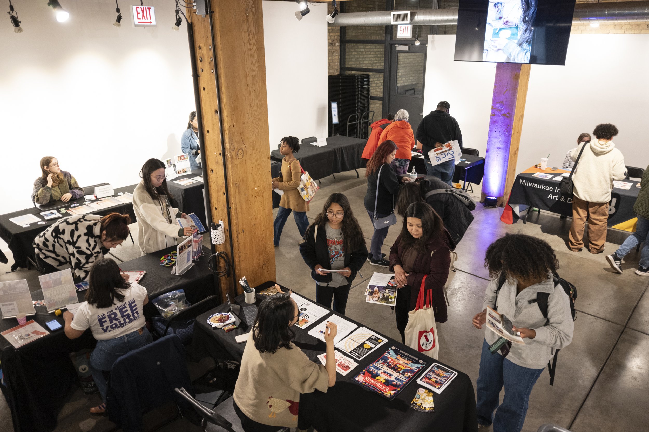 Visitors at the Marwen resource fair learn about opportunities from a variety of organizations on site on April 19, 2025. (Max Herman/for City Bureau)