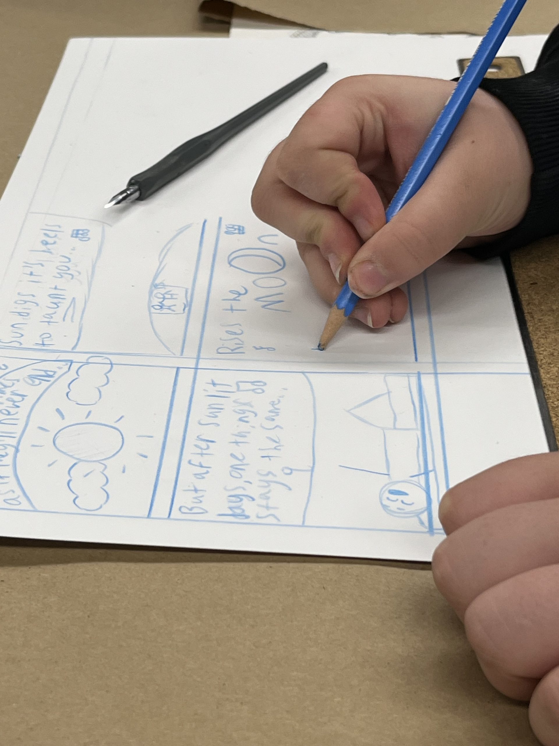Close up of a young artist drawing comic book panels.