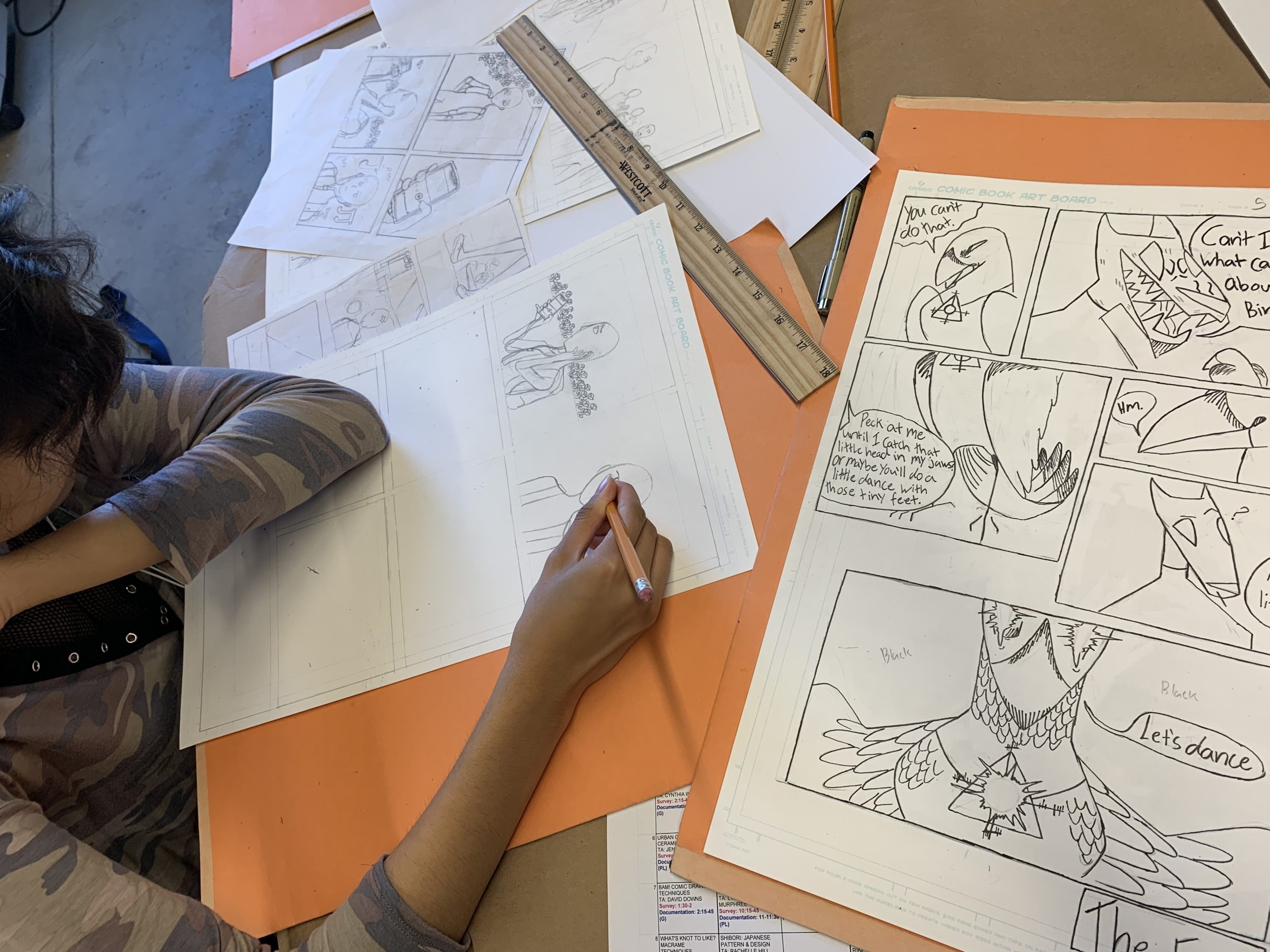 Close up of a young artist drawing comic book panels.