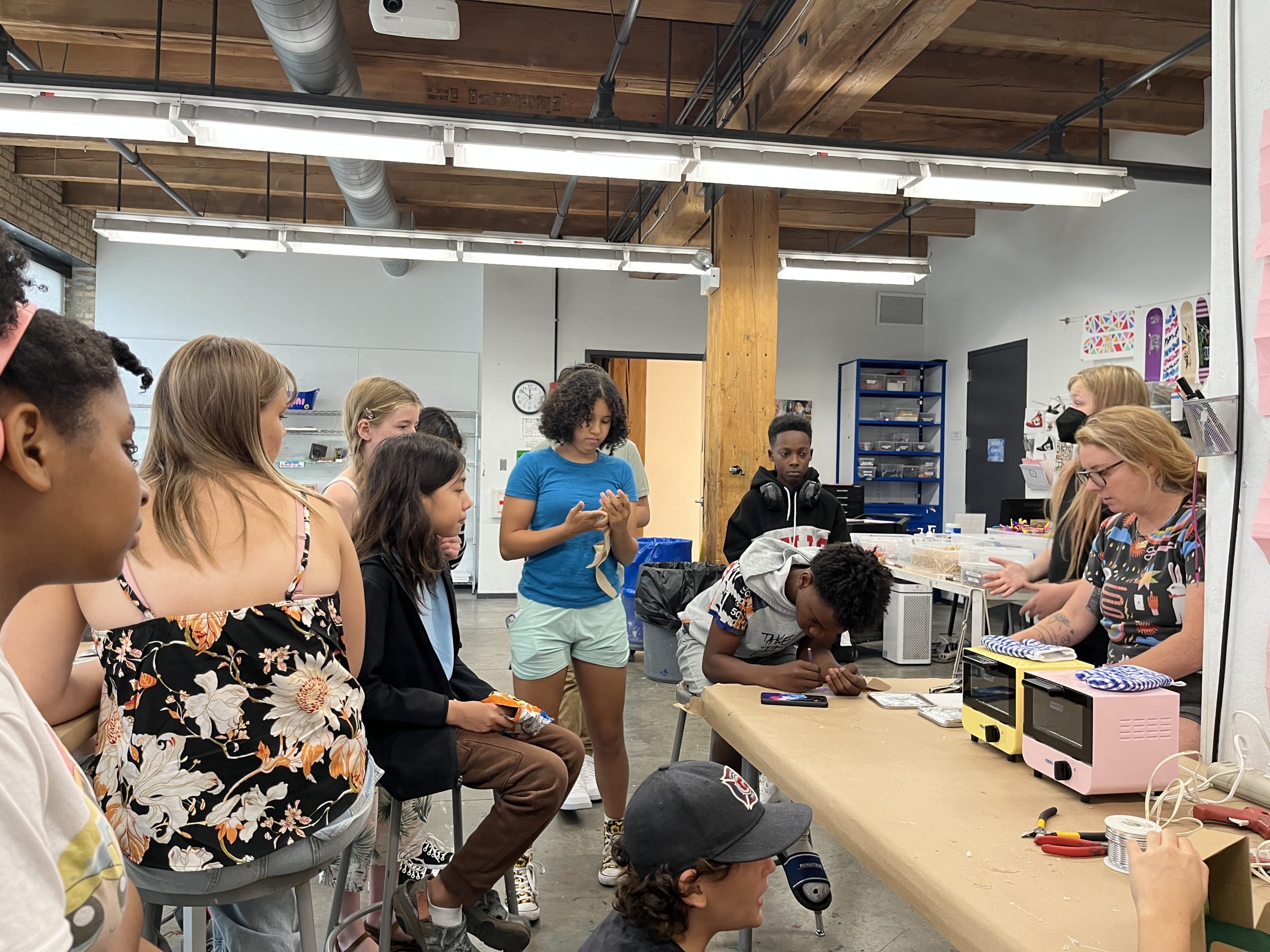 Young artists sculpting mini world dioramas.