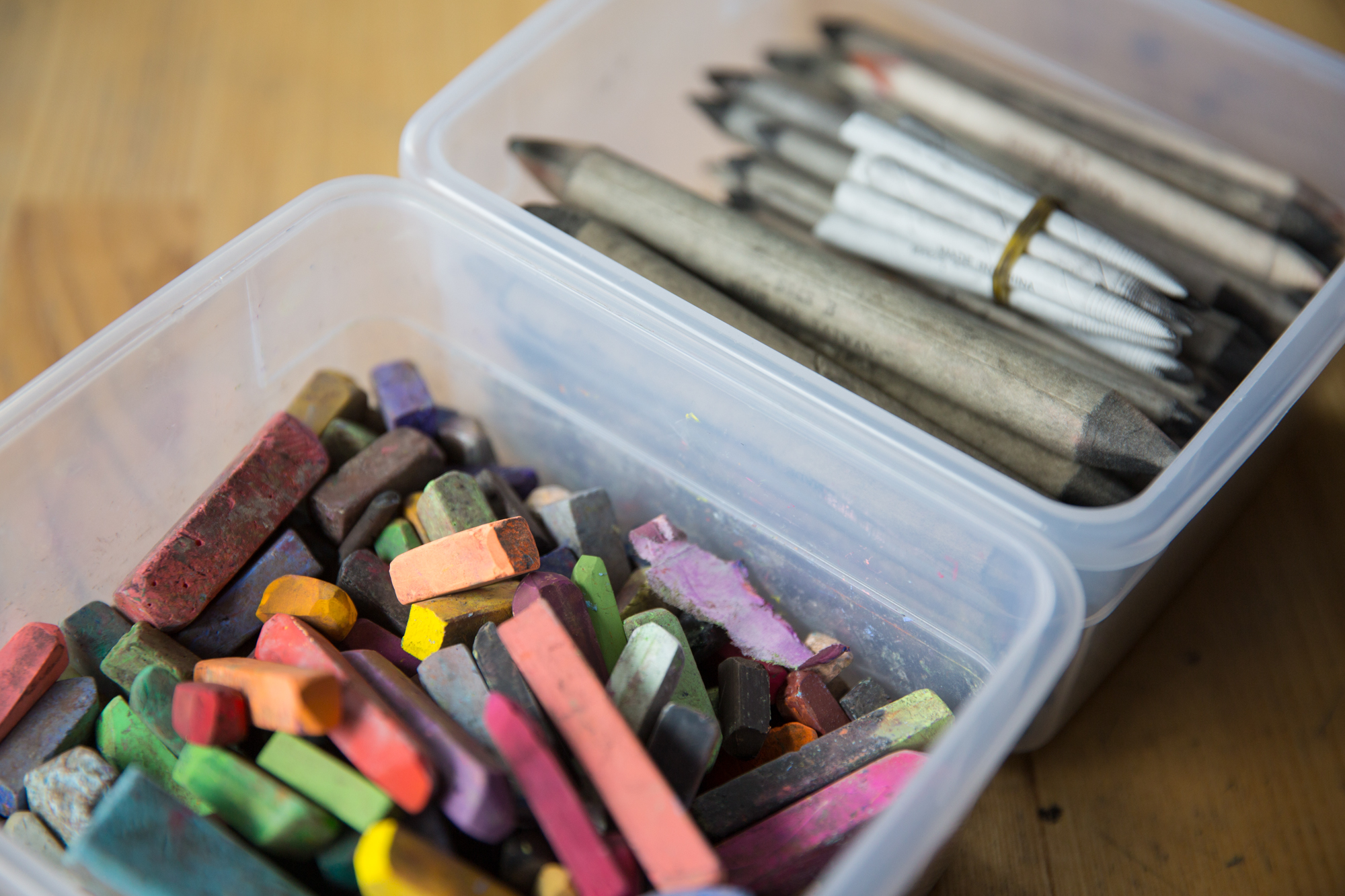 ForTheMedia_170907_MarwenAnualReport_MixedMedia-293 - Marwen Bins of pastels and blenders sit atop a wooden table.