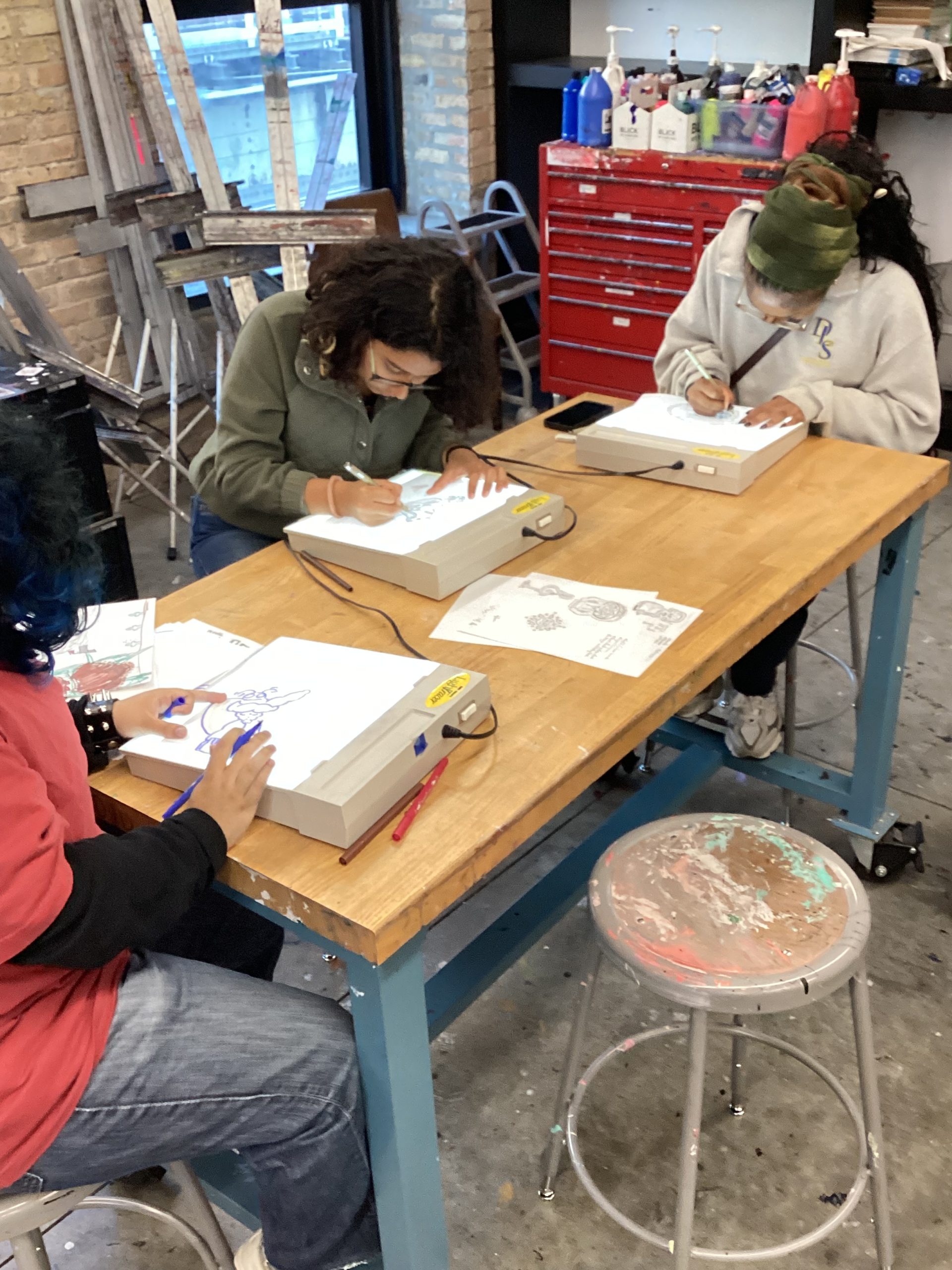 Young Artist Samara uses a light box to practice drawing techniques 