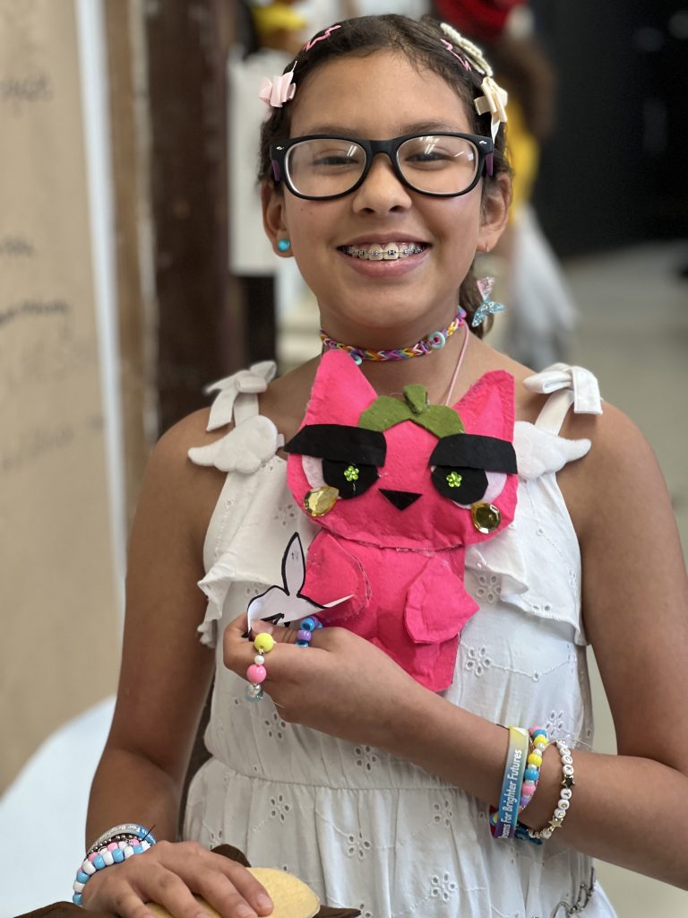 Marwen Young Artist Mia poses with an adorable plushie 