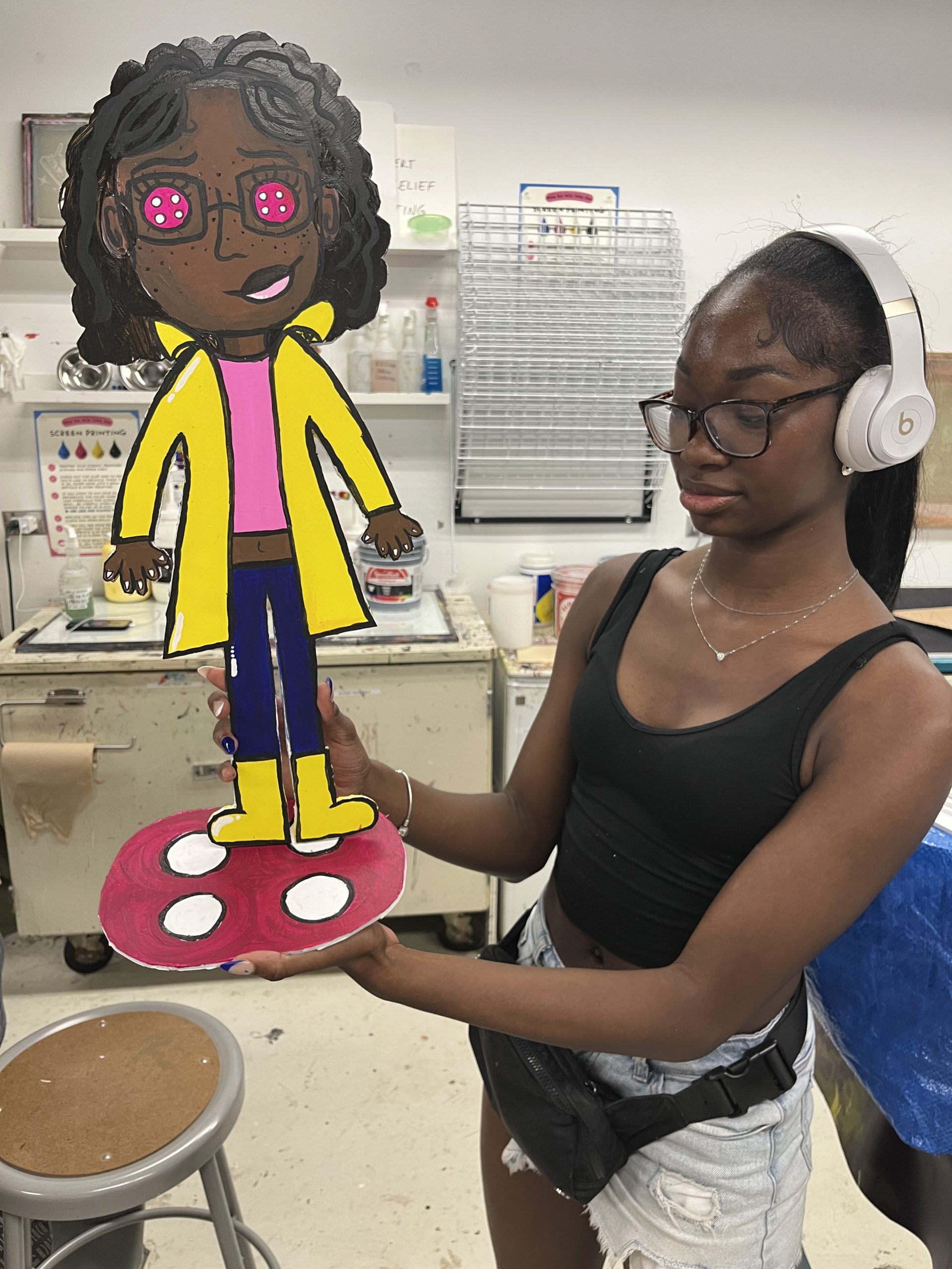 A Marwen young artist shows off their 3D paper sculpture